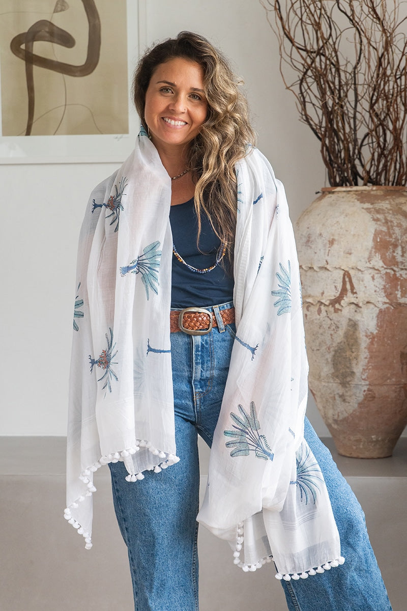 Ladies scarf, hand-loomed and hand block printed with pom poms. 70% Silk & 30% Cotton. Sundara scarf in Aqua Blue Palm print