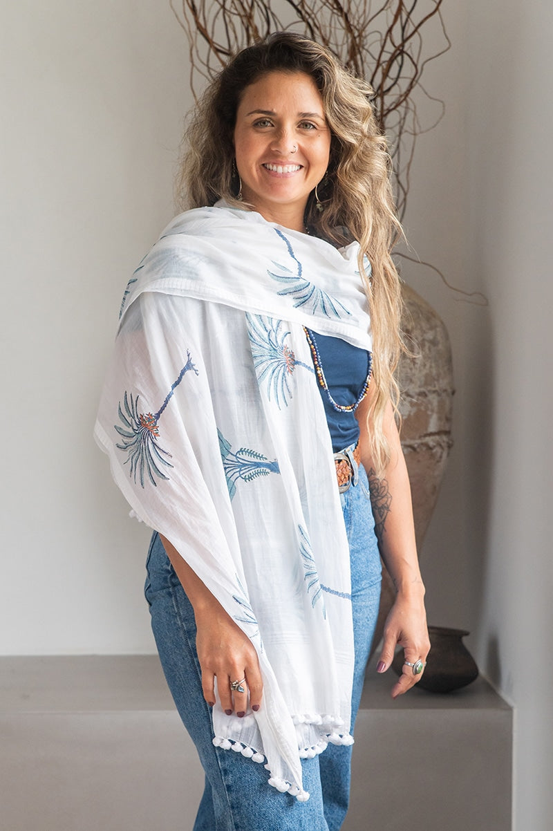 Ladies scarf, hand-loomed and hand block printed with pom poms. 70% Silk & 30% Cotton. Sundara scarf in Aqua Blue Palm print