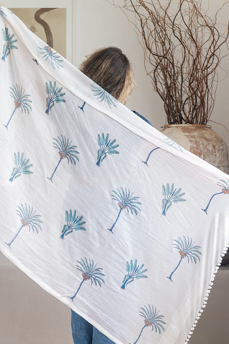 Ladies scarf, hand-loomed and hand block printed with pom poms. 70% Silk & 30% Cotton. Sundara scarf in Aqua Blue Palm print
