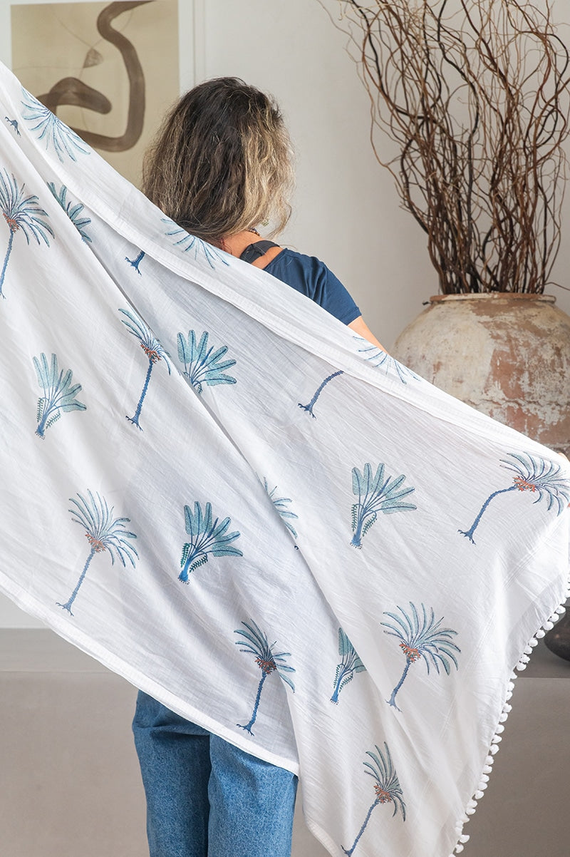 Ladies scarf, hand-loomed and hand block printed with pom poms. 70% Silk & 30% Cotton. Sundara scarf in Aqua Blue Palm print